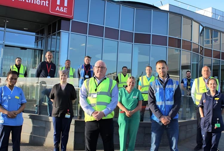 Image of Barons' director surrounded by NHS staff.